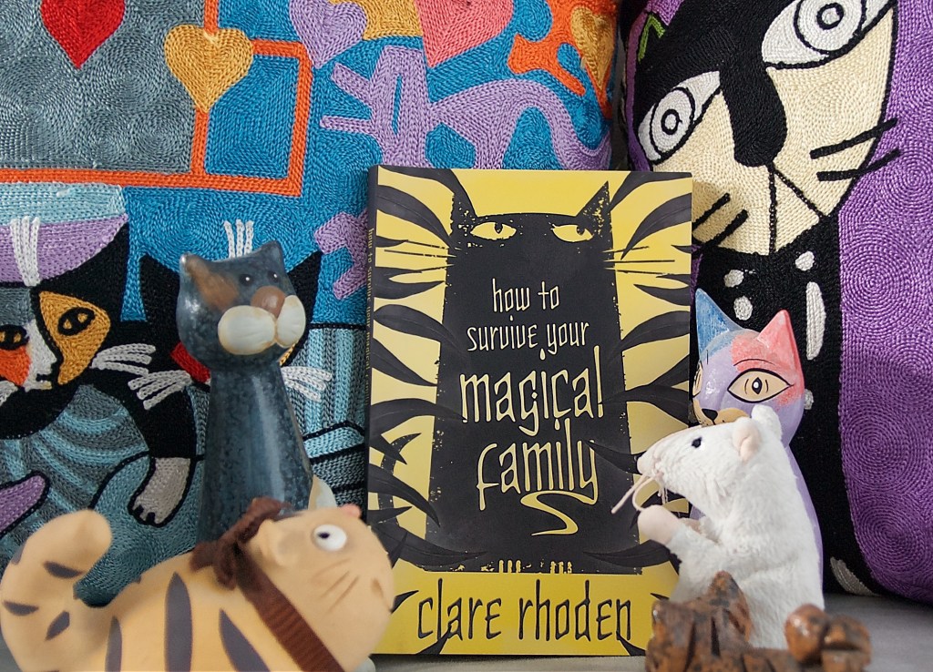 Our Office Ratty and some cats reading and reviewing How to Survive Your Magical Family, by Clare Rhoden.
