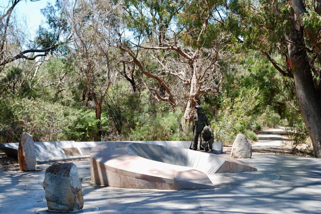 The Memorial Grove stands against bush land